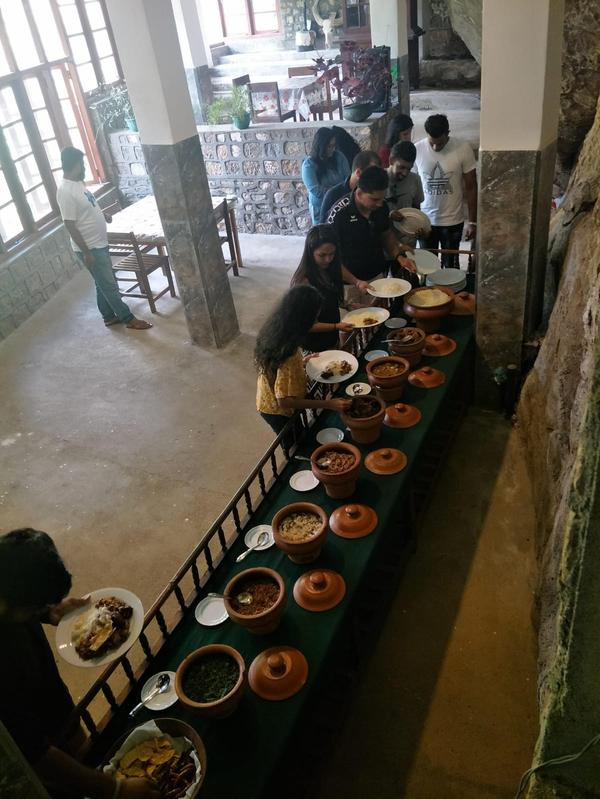 Guests serving from clay pot buffet